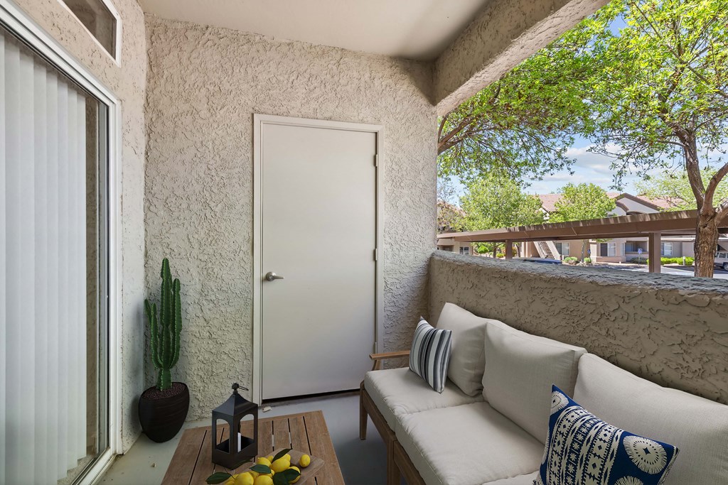 a small porch with a couch and a table at Altezza High Desert, Albuquerque, 87111